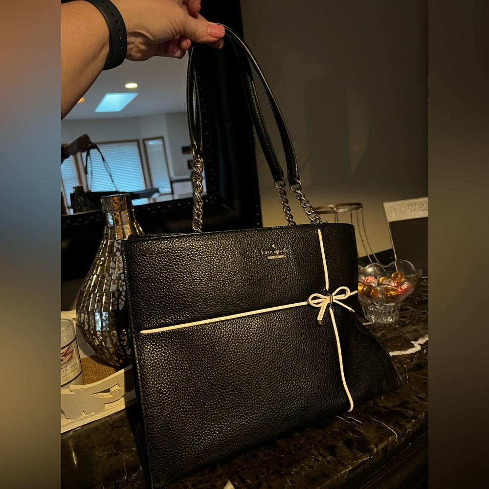 Gorgeous Kate Spade back with gold detail and white leather piping on front.